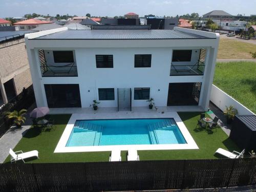 an aerial view of a house with a swimming pool at Casa Tua Suriname New 4 bedroom Townhouse 14B in Paramaribo