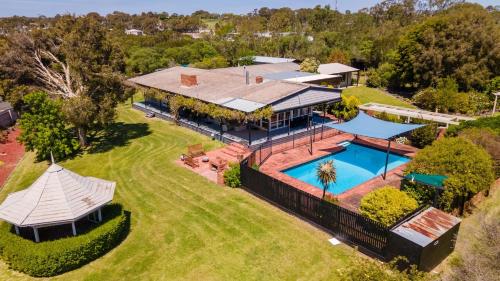an aerial view of a house with a swimming pool at Chenu Lakeside Homestead in Eagle Point