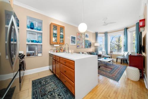 a kitchen and living room with a counter and a refrigerator at 2F Chicago's Little Italy near West Loop & Downtown in Chicago