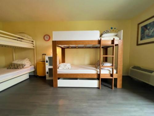 a room with two bunk beds and a bathroom at Bposhtels Orlando Florida Mall in Orlando