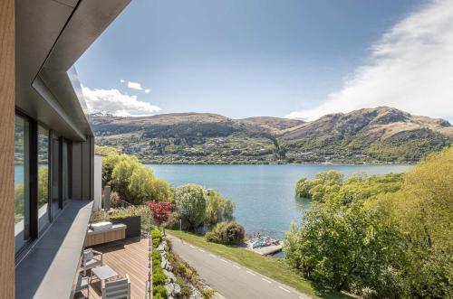 a view of a lake from a house at Willow Waters - lakeside luxury - a Relax it's Done holiday home in Frankton Wharf