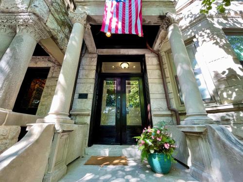 a flag hanging over a door with a vase of flowers at 2F Chicago's Little Italy near West Loop & Downtown in Chicago