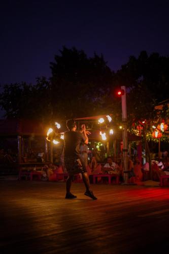 a couple of people dancing in the street at night at PinkCoco Gili Trawangan - Constant Surprises - for Cool Adults Only in Gili Trawangan