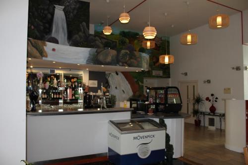 a bar in a room with a lot of alcohol at Desalis Hotel London Stansted in Elsenham