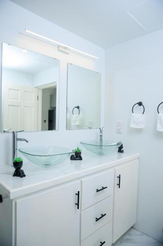 a bathroom with two sinks and a large mirror at Caldera Villas in Soufrière