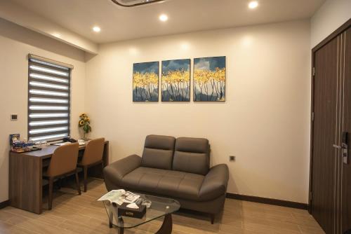 a living room with a couch and a table at ZEN RIVERSIDE HOTEL & RESIDENCES in Hai Phong