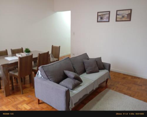 a living room with a couch and a table at Apto grande na pompeia in Sao Paulo