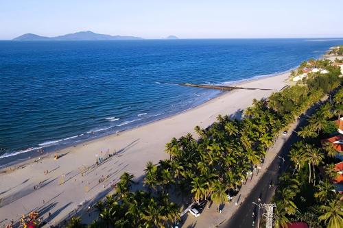 an aerial view of a beach with palm trees and the ocean at Wyndham Garden Hoi An Cua Dai Beach in Hoi An