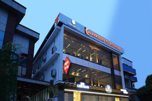 a building with a sign on top of it at Super Townhouse Edasserys Kalamassery Tourist Home in Cochin