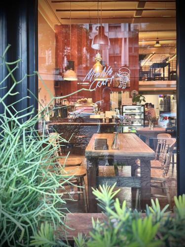 a window of a restaurant with a table and chairs at Mana Craft Stay in Bangkok