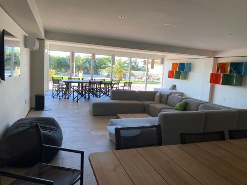 a living room with a couch and a table at Ocean&airport view condo with pool&gym in Maho, walk to Maho Beach and Mullet Bay in Maho Reef