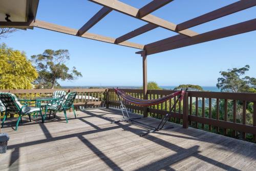 a patio with chairs and a hammock on a deck at Bayview Escape McCrae in McCrae
