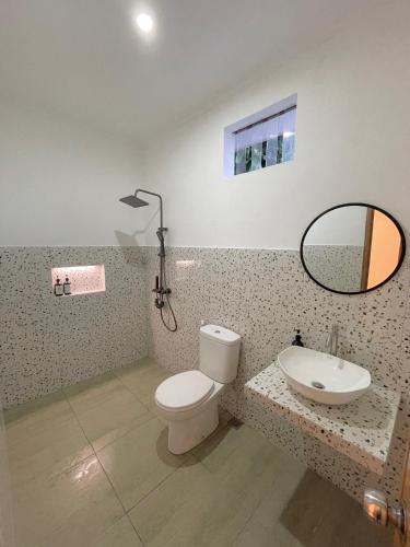 a bathroom with a toilet and a sink and a mirror at Kataleya Villa, Punclut 4BR in Bongkar 2