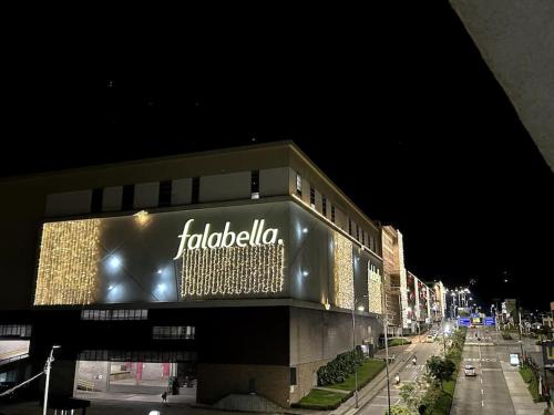 a building with a sign on the side of it at Comodo Apto Diagonal MALL PLAZA in Manizales