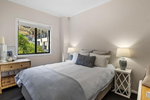 a bedroom with a bed and a window at Shoreline Escape in Wirrina Cove