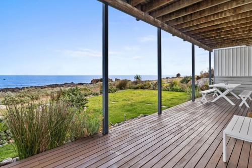 a wooden deck with a view of the ocean at Shoreline Escape in Wirrina Cove