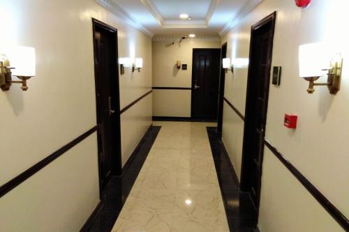 a corridor in a building with two doors and a hallway at Venezia Suites Hotel Iloilo in Iloilo City