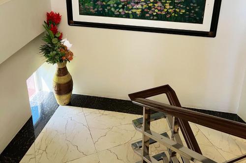 a staircase with a vase with a flower in it at Venezia Suites Hotel Iloilo in Iloilo City
