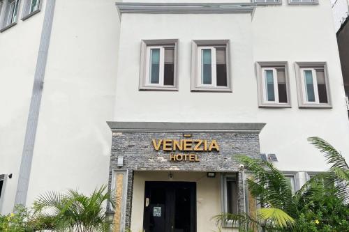 a white building with a sign that reads venza hotel at Venezia Suites Hotel Iloilo in Iloilo City