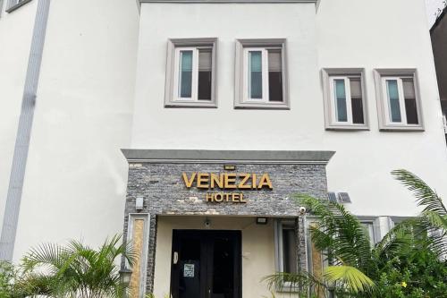 a building with a sign that reads venza hotel at Venezia Suites Hotel Iloilo in Iloilo City