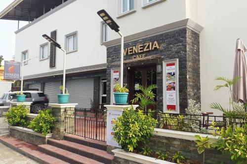 a vivenka cafe with plants outside of a building at Venezia Suites Hotel Iloilo in Iloilo City
