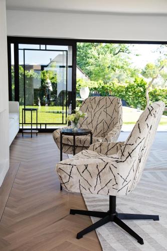a living room with a chair and a table at Coco Queen in Paarl