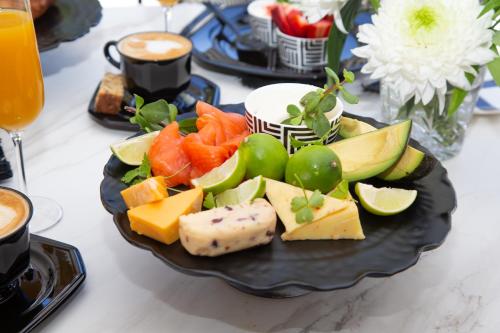 a plate of cheese and fruit on a table at Coco Queen in Paarl