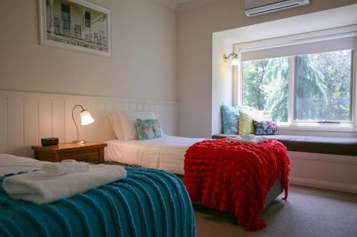 Un dormitorio con dos camas y una ventana. en Dieudonne, en Harrietville