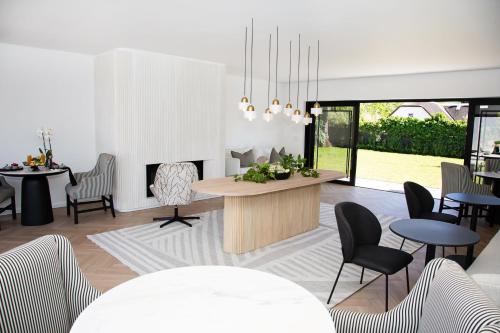 a living room with tables chairs and a fireplace at Coco Queen in Paarl