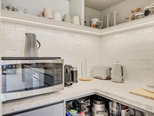 a kitchen with a microwave on a counter at Elsinor 6 in Mulwala