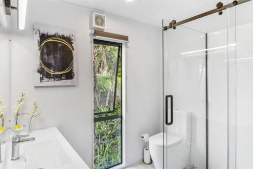 a bathroom with a sink and a toilet and a window at Paradise Near Palm Beach in Palm Beach