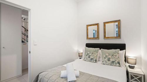 Ένα ή περισσότερα κρεβάτια σε δωμάτιο στο Gordon House Apartments