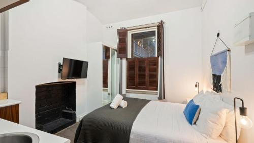 Ένα ή περισσότερα κρεβάτια σε δωμάτιο στο Gordon House Apartments