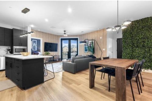 a kitchen and living room with a table and a couch at Electric - Odyssey -Top Floor West End 2 Bedroom - Minutes to Broadway in Nashville