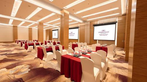 a conference room with tables and chairs and a screen at Crowne Plaza Chengdu Panda Garden by IHG-Near Panda Base in Chengdu