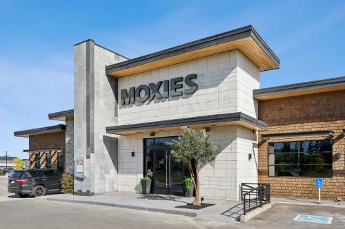 a moxes store with a sign on the front of it at Sandman Hotel Calgary Airport in Calgary