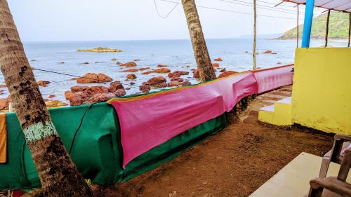 a hammock on the beach next to the ocean at Shree Sai Beach Stay in Arambol