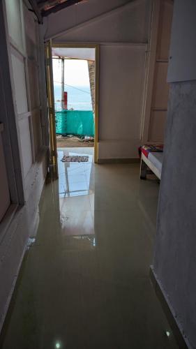 an empty room with a floor of water on the floor at Shree Sai Beach Stay in Arambol