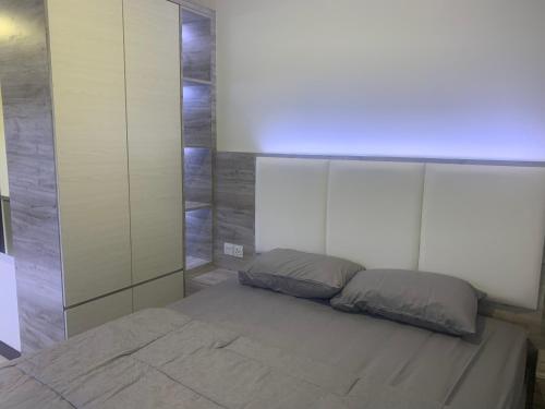 a bedroom with a bed with a large headboard at COMFORTSTAY-Citra Plaza Nagoya #31-06 Sea View in Jodoh