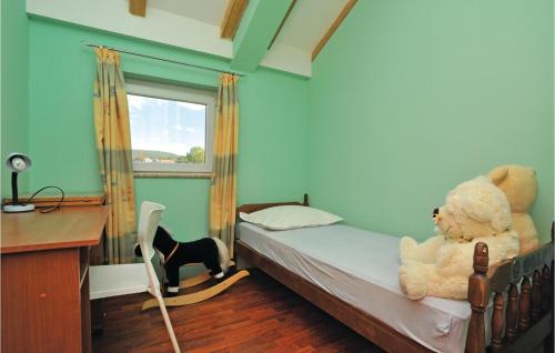 a bedroom with a teddy bear sitting on a bed at Holiday Home Trilj 85 With Outdoor Swimmingpool in Trilj
