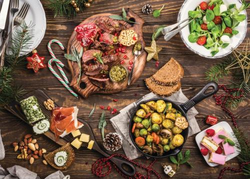 a table topped with a turkey and a pan of food at Crowne Plaza Surfers Paradise by IHG in Gold Coast