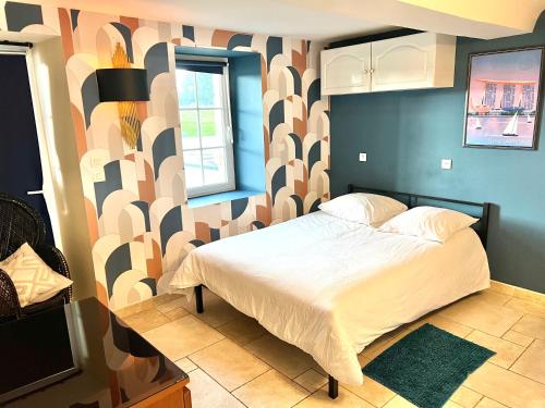 a bedroom with a large bed with a patterned wall at The Chateau 45Pers, 30min from Sea in Amayé-sur-Orne