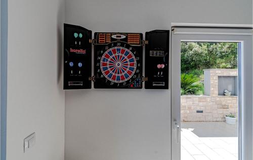 a dart board on a wall next to a door at Pet Friendly Home In Prigradica in Prigradica