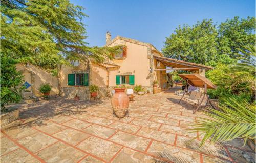 a house with a stone patio in front of it at Lovely Home In Partanna With Wifi in Partanna