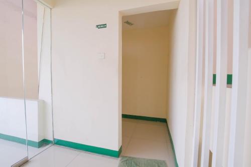 a hallway with a glass door in a room at Le Paris Syariah Residence in Tangerang