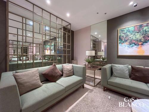 a living room with a couch and a table at Studio Unit CaSaBlanco near Ayala Mall Cebu in Cebu City