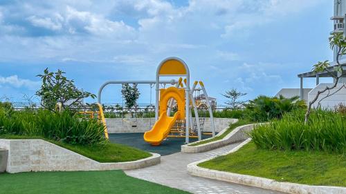 a playground with a yellow slide in a park at Studio Unit CaSaBlanco near Ayala Mall Cebu in Cebu City