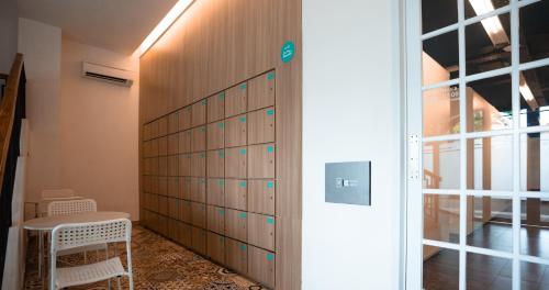 a wall of lockers in a room with a table at Bobopod Slamet Riyadi, Solo in Solo