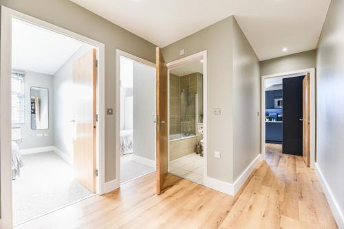 a hallway with two doors and a bathroom at Luxury Prime Location Manchester Flat in Manchester