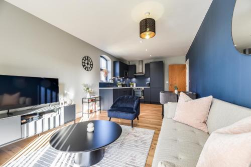 a living room with a couch and a table at Luxury Prime Location Manchester Flat in Manchester